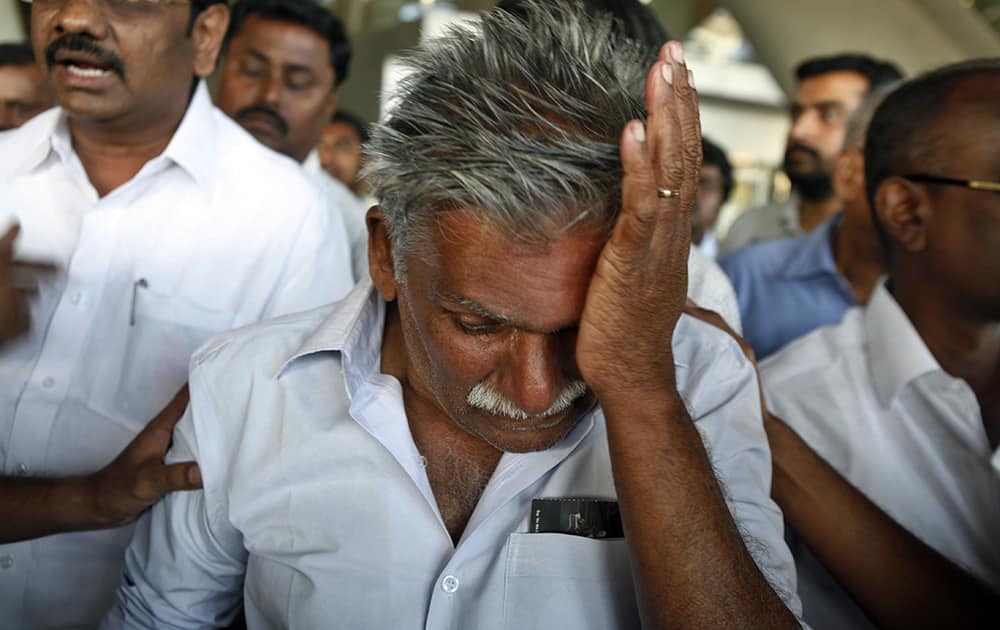A survivor of a boat capsize off India`s Andaman and Nicobar islands gets emotional upon seeing relatives as he arrives at the airport in Chennai. The overcrowded tourist boat that capsized Sunday killing at least 21 people, may have hit a rock before it went down, police said Monday.
