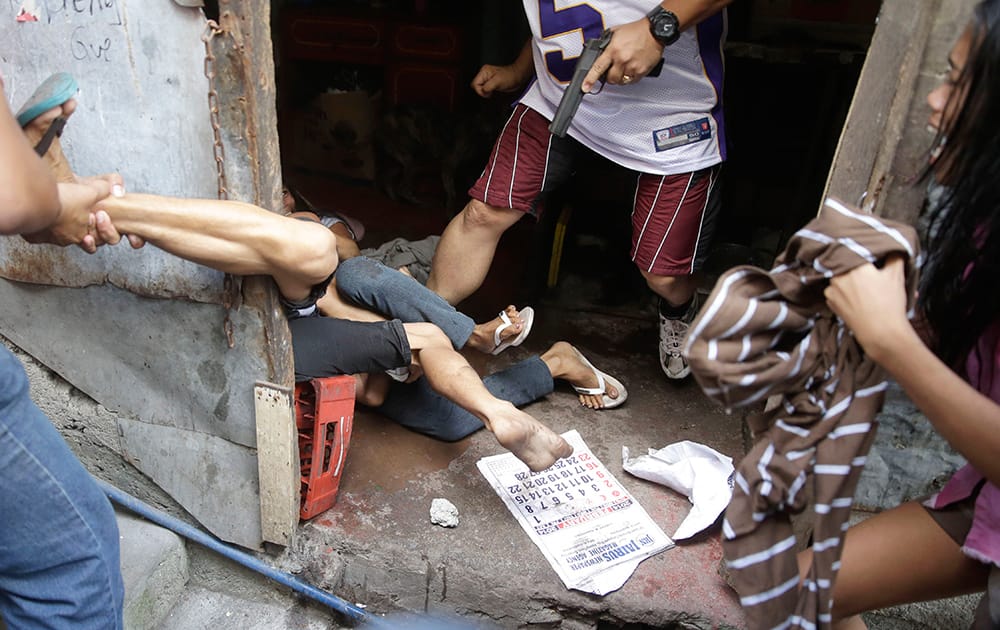Plainclothes police arrest a resident who allegedly threw rocks at them as they enforce the demolition of their shanties at the sprawling community of informal settlers at suburban Quezon city northeast of Manila, Philippines.