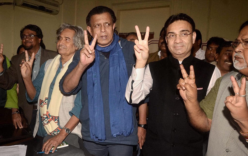 Mithun Chakraborty along with K D Singh, Painter Jogen Chowdhury, Ahemed Hussan of Trinamool congress show victory sign after filling nomination papers to Assembly Secretary as a Trinamool Congress candidate in Rajya Sabha Election in Assembly House in Kolkata.