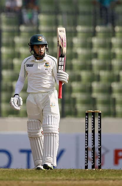 Bangladesh’s captain Mushfiqur Rahim acknowledges the crowd after scoring fifty runs during the first day of the first test cricket match against Sri Lanka, in Dhaka, Bangladesh.