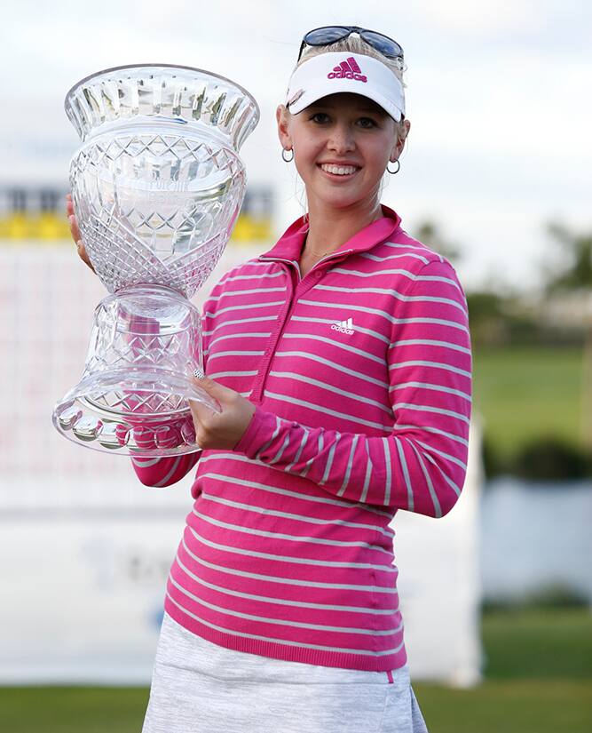 Jessica Korda of the US holds her trophy as she poses for photographers following her victory at the LPGA Pure Silk Bahamas Classic at the Ocean Club Golf Course, Paradise Island, Bahamas.