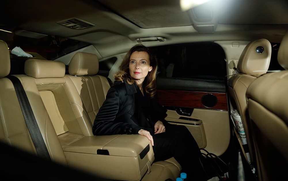 Valerie Trierweiler, former partner of French President Francois Hollande, looks on from a car as she leaves Chhatrapati Shivaji International Airport after her arrival in Mumbai.