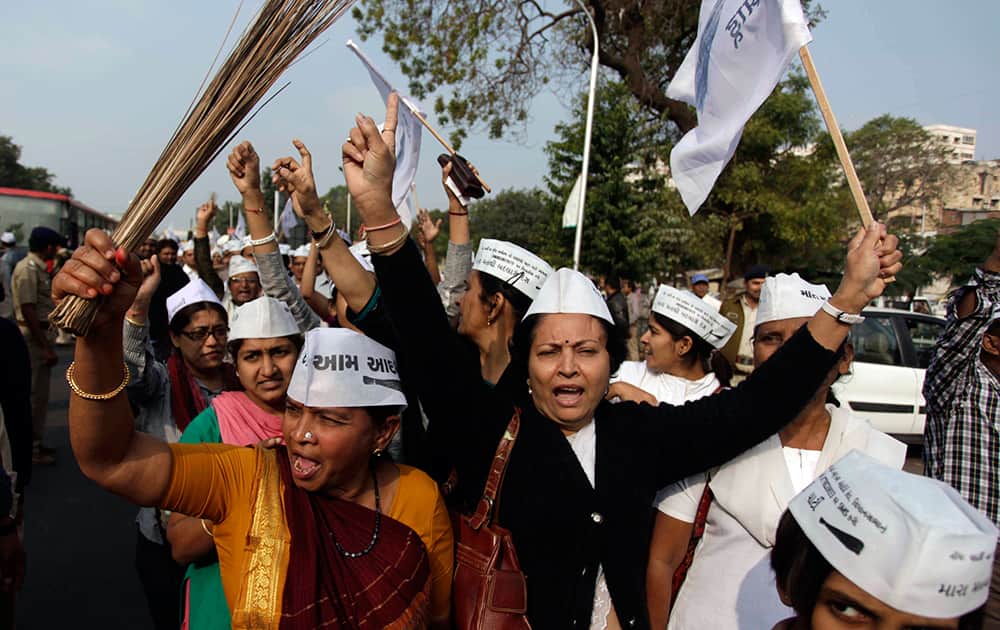 Supporters of India`s Aam Admi, or Common Man`s, party, shout slogans carrying broom, the party symbol, as they march towards Gandhinagar, ahead of the death anniversary of Mahatma Gandhi in Ahmedabad.