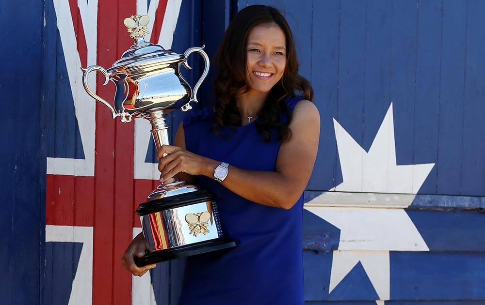 China`s Li Na poses for photos at Brighton Beach with her Australian Open trophy following her win over Slovakia`s Dominika Cibulkova in Melbourne.