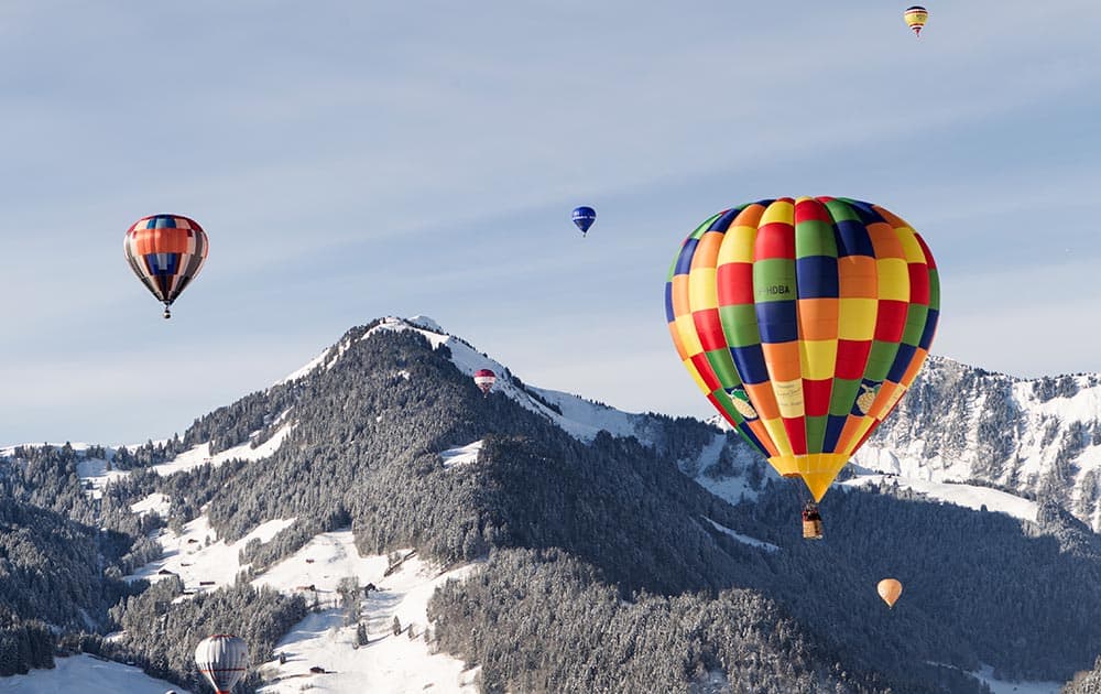 Hot air balloons take off during the 36th International Hot Air Balloon week, in the skiing resort of Chateau d`Oex, in the Swiss Alps.