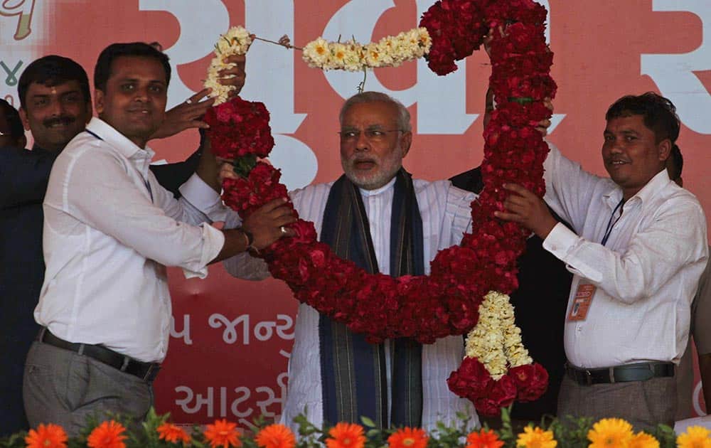 India`s main opposition Bharatiya Janata Party’s (BJP) prime ministerial candidate and Gujarat Chief Minister Narendra Modi receives a garland during a youth convention at Himatnagar, about 80 kilometers from Ahmedabad.