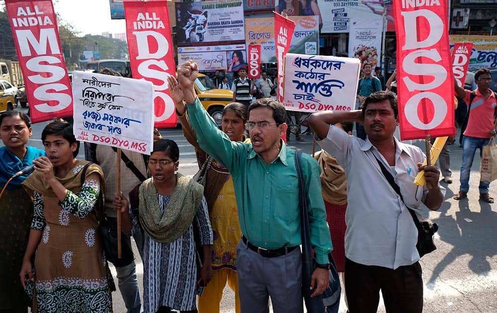Activists of All India Democratic Students` Organization shout slogans as they block a road protesting the gang rape of a 20-year woman in Subalpur, in Kolkata.