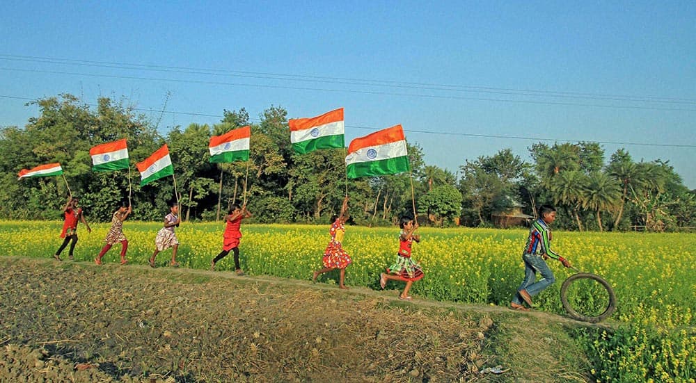 Children run with tri-colour Flag on the eve of Republic Day celebrations at Darpasila in Birbhum district of West Bengal on Saturday morning.