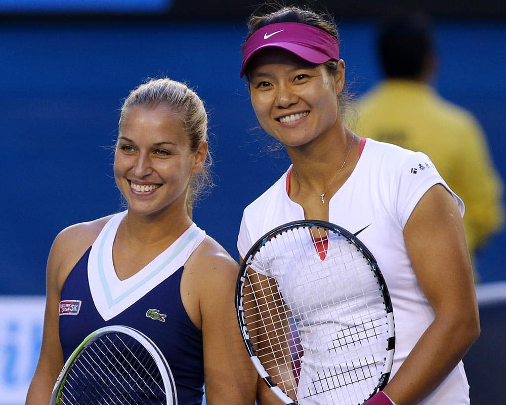Li Na of China and Dominika Cibulkova of Slovakia pose for a photo at the net, prior to their women`s singles final at the Australian Open tennis championship in Melbourne.