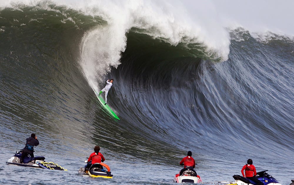 Nic Lamb rides a wave during the third heat of the first round of the Mavericks Invitational big wave surf contest, in Half Moon Bay, Calif.