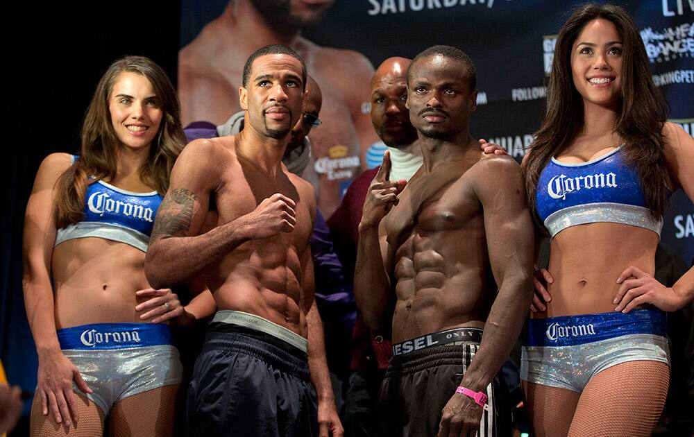 IBF junior welterweight champion Lamont Peterson, left, and challenger Dierry Jean, right, of Canada, pose for photographers during the official weigh in, in Washington.