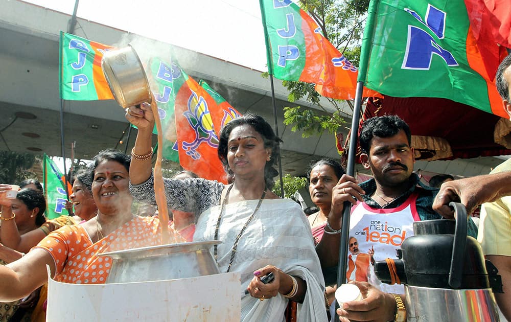 BJP Mahila wing members make tea during a protest against Congress leaders for their remarks on party PM candidate Narendra Modi, in Bengaluru.