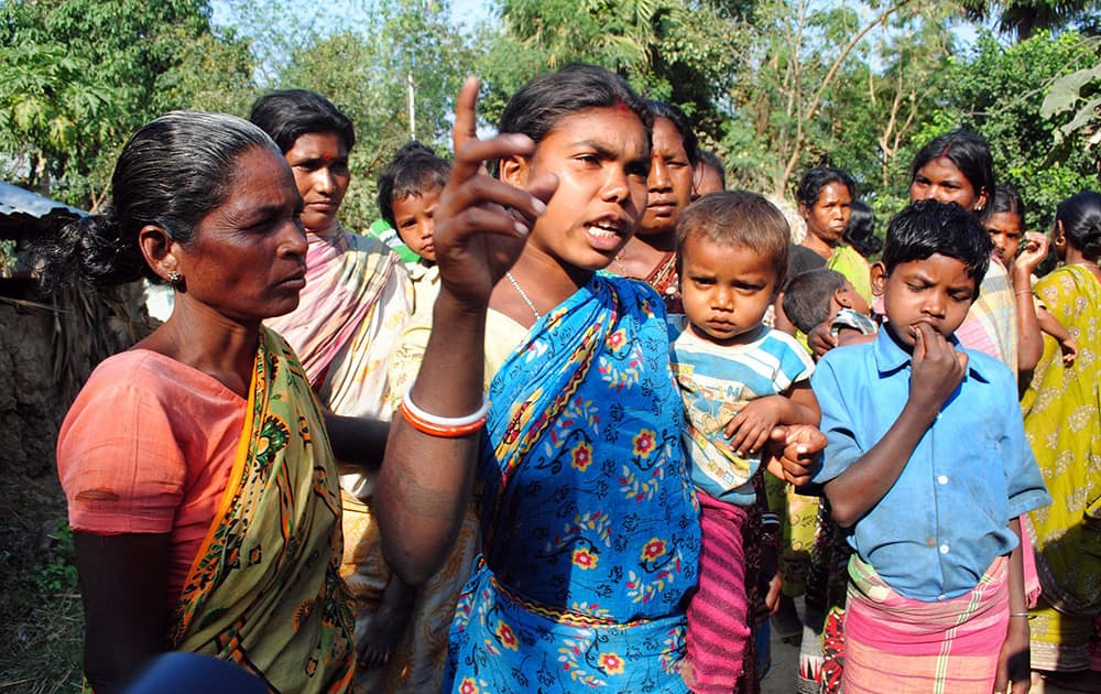 An Indian Santhal tribal woman carrying a child speaks to the media in connection with the gang rape of a woman at Subalpur village, in Birbhum district, about 180 kilometers (110 miles) north of Kolkata, the capital of the eastern Indian state of West Bengal.