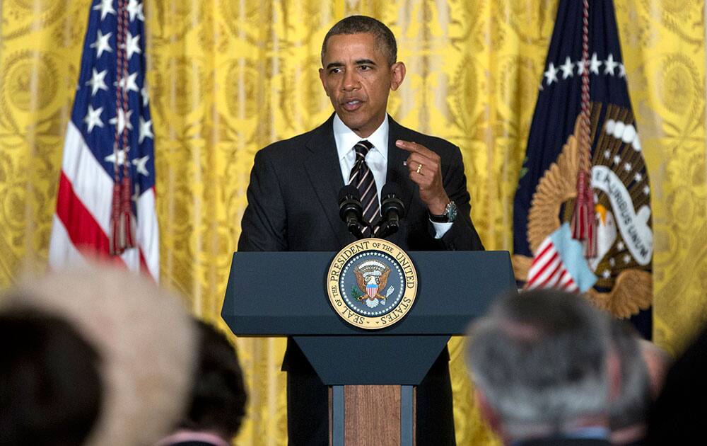 President Barack Obama gestures as he speaks during an reception for the US Conference of Mayors in the East Room of the White House.