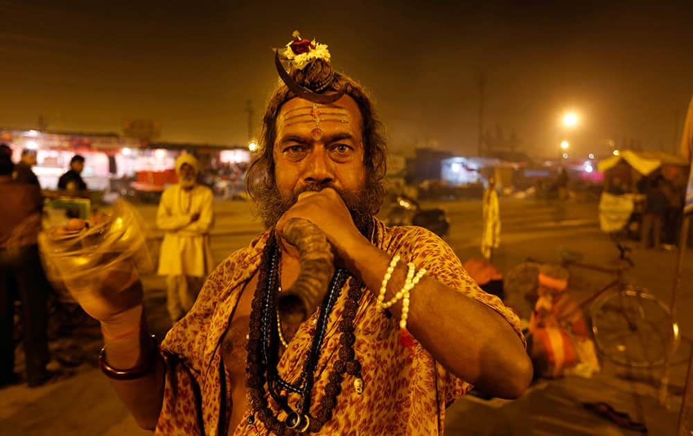 A Sadhu, or Hindu holy man, performs evening rituals at Sangam, the confluence of the Ganges, Yamuna and mythical Saraswati river, during the annual traditional fair ` Magh Mela` in Allahabad.