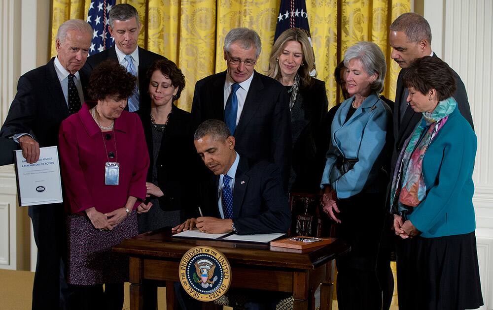 President Barack Obama signs a memorandum creating a task force to respond to campus rapes during an event for the Council on Women and Girls, in the East Room of the White House in Washington.