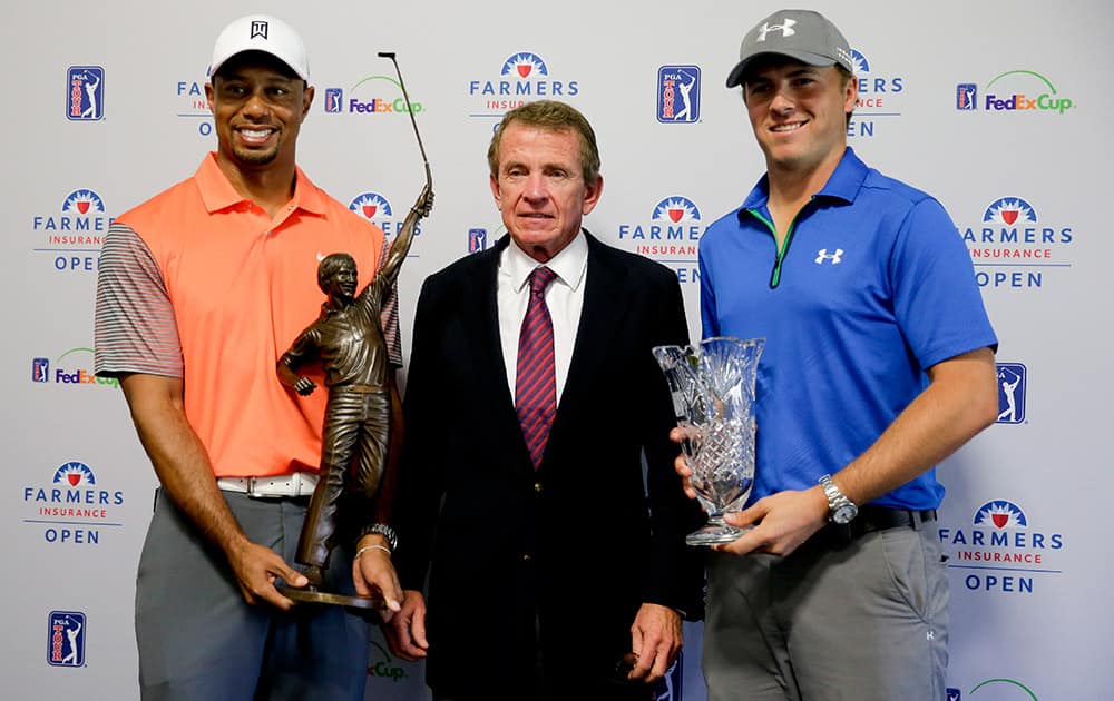 Tiger Woods, left, 2013 PGA Tour Player of the Year, and Jordan Spieth, right, PGA Tour Rookie of the Year, pose with PGA Tour Commissioner Tim Finchem and their trophies during a presentation at the Farmers Insurance Open golf tournament at Torrey Pines Golf Course in San Diego.