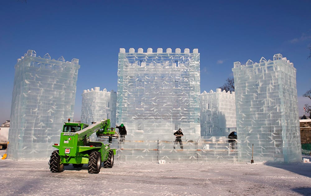 Workers put the finishing touches on the carnival ice castle during sub-zero temperatures in Quebec City.