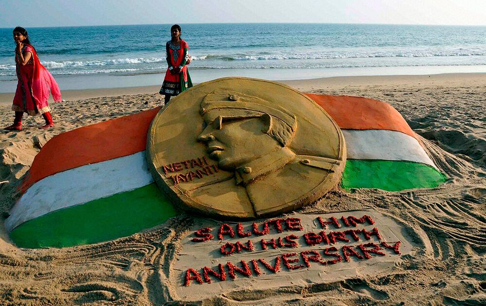 Sand artist Manash Sahoo makes a sand scuplture of Netaji Subash Chandra Bose on the occasion of his 115th birth anniversary in Puri.