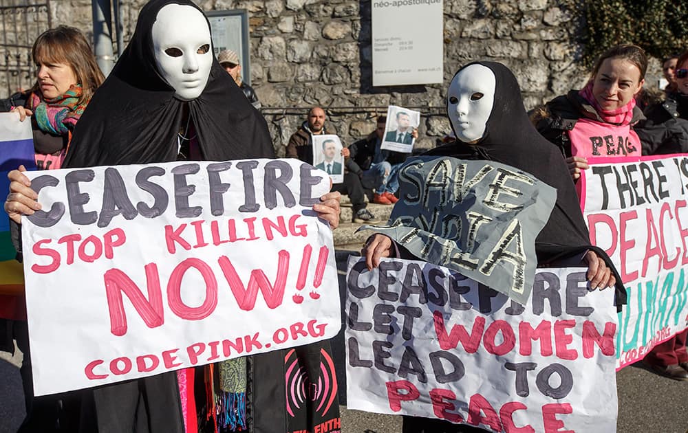 Masked members of the movement `Codepink women for peace` protest near the hotel, during the opening of the Geneva II peace talks on Syria , in Montreux, Switzerland.