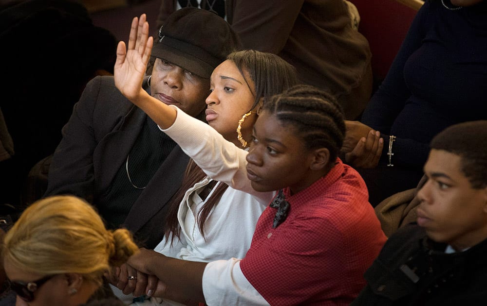 Ashlee Dobson, mother of Myls Dobson, raises her hand during the funeral of her 4-year-old son Myls Dobson at the First Corinthian Baptist Church, in the Harlem neighborhood of New York.