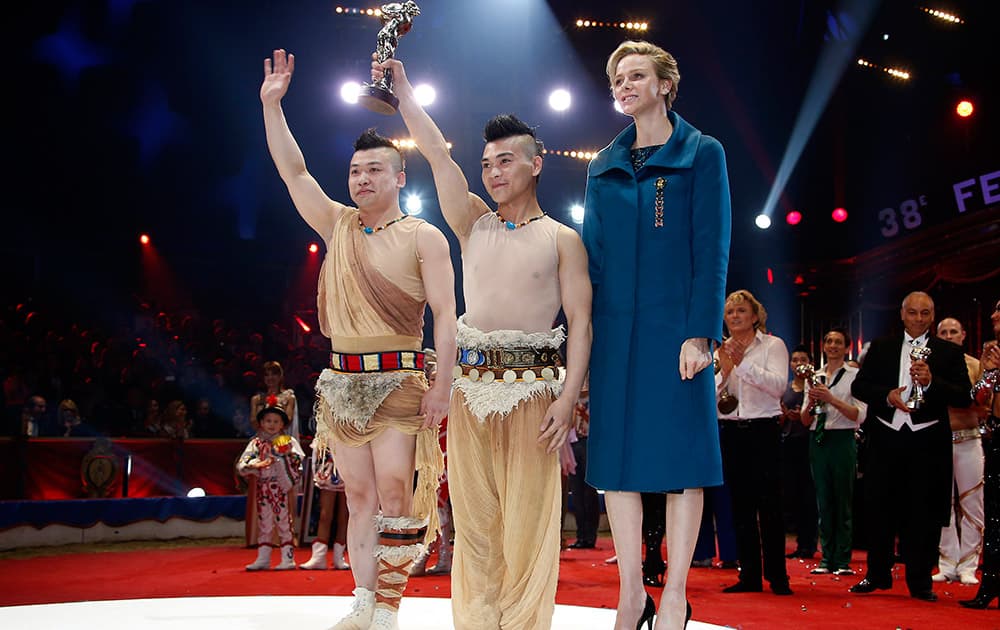 Chinese equilibrist duo of the Suining troupe pose with Princess Charlene of Monaco, right, after receiving a Bronze clown during the Award Gala evening of the 38th International Circus Festival of Monte Carlo in Monaco.