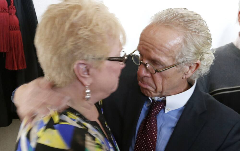 Attorney Jeff Anderson hugs Kathy Laarveld, whose son was sexually abused by a priest, after a new conference on the release of files of Catholic priests credibly accused of sexually abusing minors in the Archdiocese of Chicago.