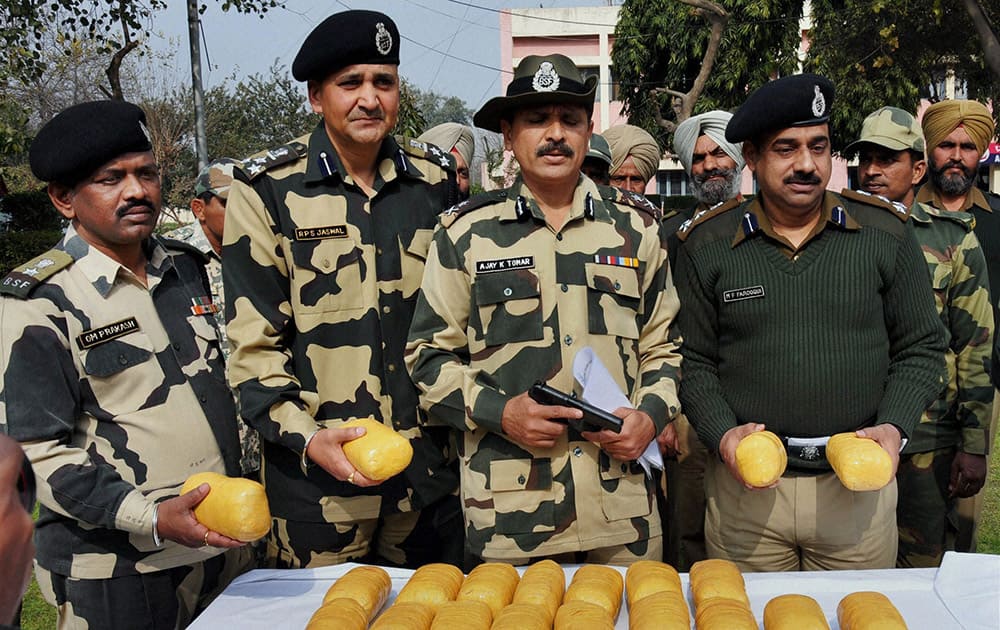 BSF officers and jawans showing 20 kilogram heroin, valued at around Rs 100 crore in international market, recovered after killing of three Pakistani smugglers near Indo Pak international border, about 50 km from Amritsar.