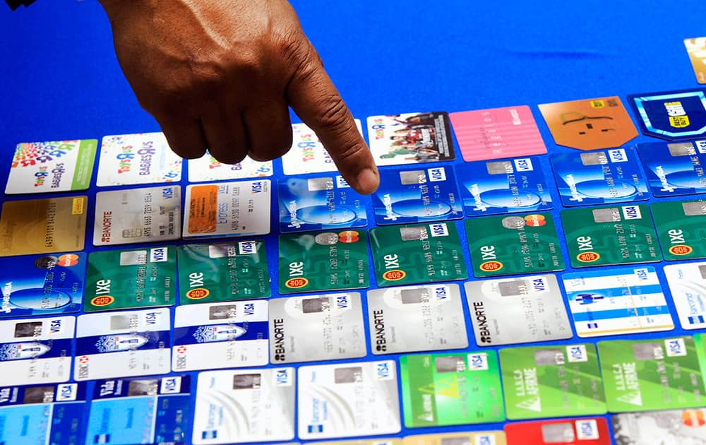 McAllen Police Chief Victor Rodriguez points at dozens of fraudulent credit cards that were confiscated by McAllen police after arresting a man and a woman on fraud charges tied to the December Target credit card breach, at the McAllen Police Department in McAllen, Texas.