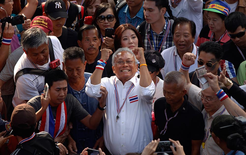 Anti-government protest leader Suthep Thaugsuban, center, rallies supporters during a march in Bangkok, Thailand.