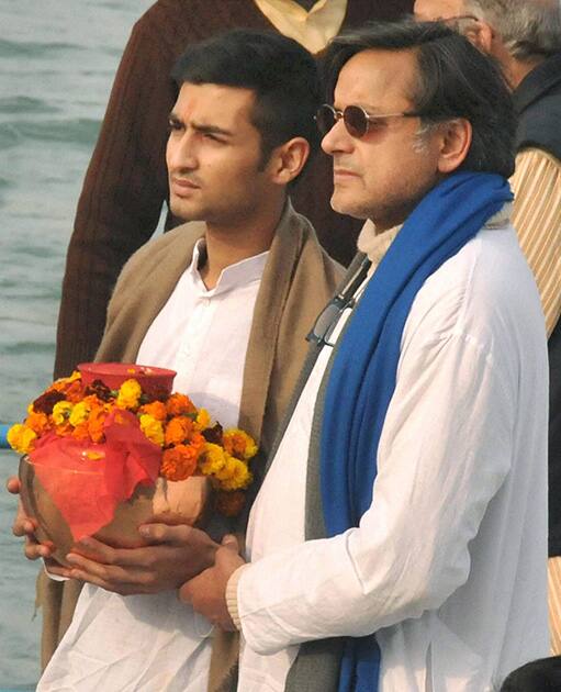 Sunanda Pushkar`s husband Union minister Shashi Tharoor and her son Shiv Menon before immersing her ashes in River Ganga in Haridwar.