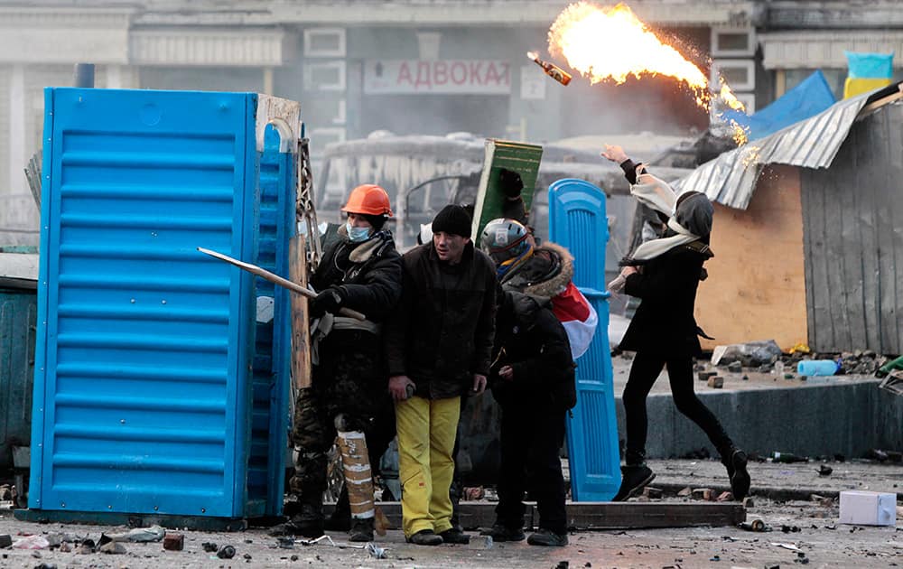 Protesters clash with police, in central Kiev, Ukraine. Protesters erected barricades from charred vehicles and other materials in central Kiev as the sound of stun grenades can be heard in the freezing air as police try to quell anti-government street protests.