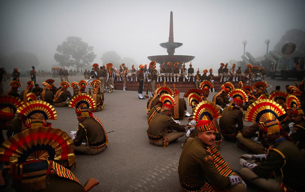 Indian soldiers wait before the beginning of rehearsals for the Republic Day parade early in the morning in New Delhi.