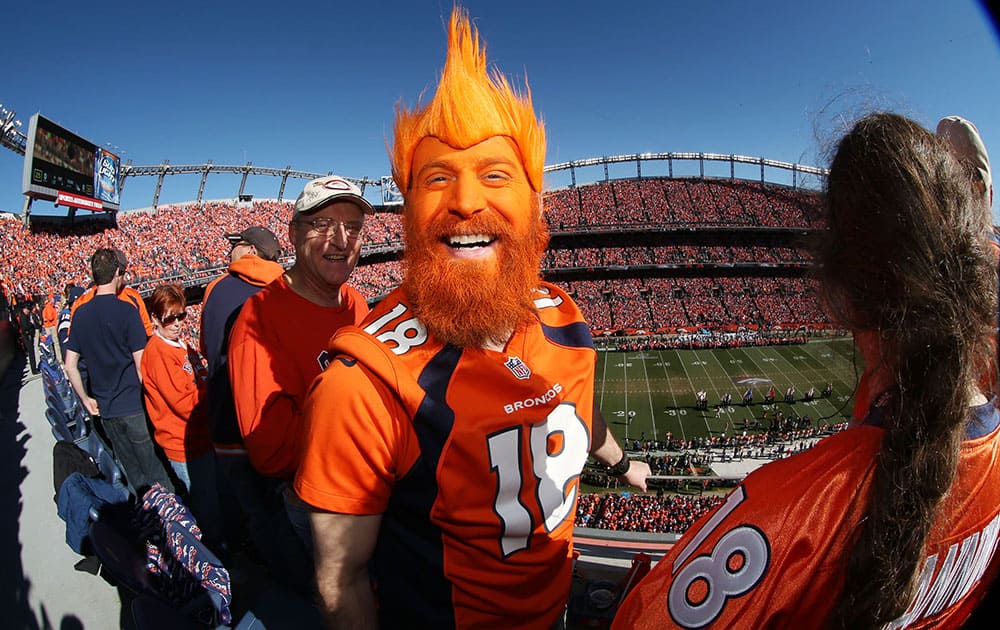 Denver Broncos fan Nick Hess, of Longmont, Colo., shows off his colors in Sports Authority Field at Mile High Stadium during the start of the AFC Championship NFL football playoff game as the Broncos host the New England Patriots in Denver.