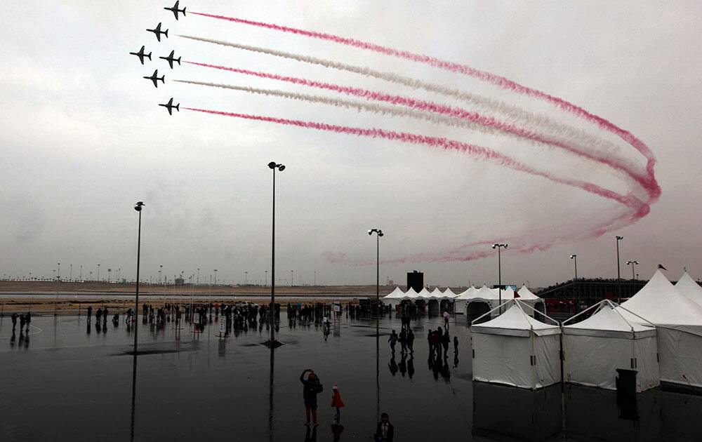 Visitors watch the Saudi Hawks, a Royal Saudi Air Force aerobatic team during the final day of the Bahrain International Airshow.