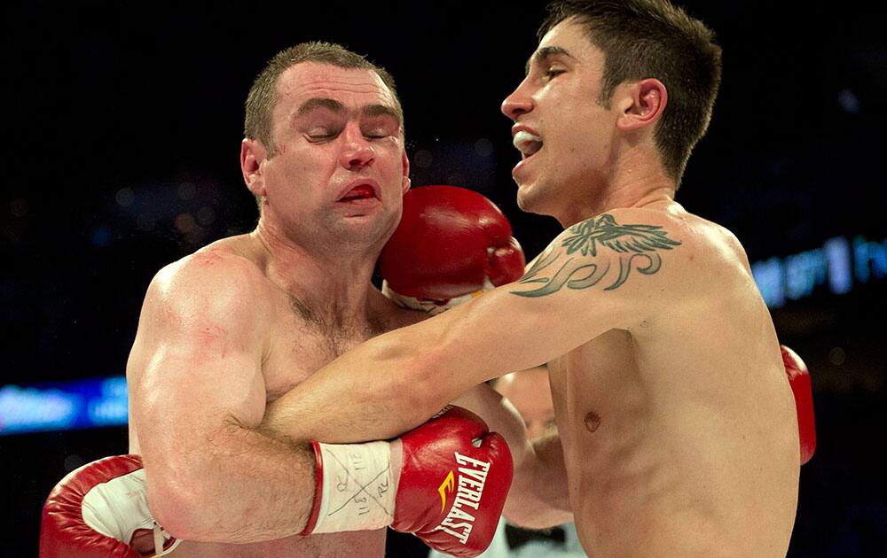 Mikael Zewski, right, of Canada, lands a right to the head of Krzysztof Szot, from Poland, during their welterweight boxing match, in Montreal. Zewski won in the seventh round.