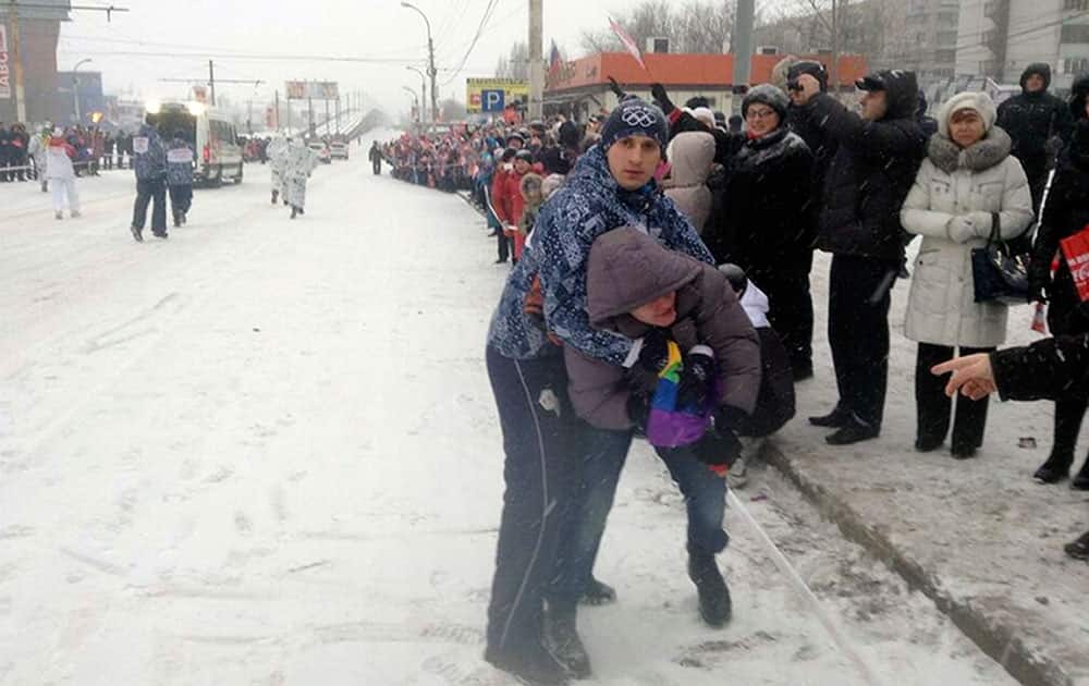 Security personnel detain Lebedev, a gay protester, during the Olympic torch relay in the city of Voronezh, 534 km (334 miles) south of Moscow.