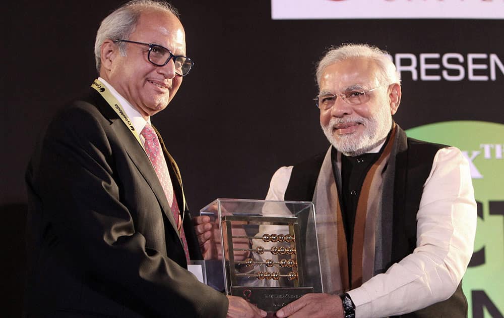 BJP`s prime ministerial candidate & Gujarat Chief Minister Narendra Modi presenting the Dataquest IT Person of the Year award to CP Gurnani, MD & CEO of Tech Mahindra at the 20th ICT Business Awards in New Delhi.