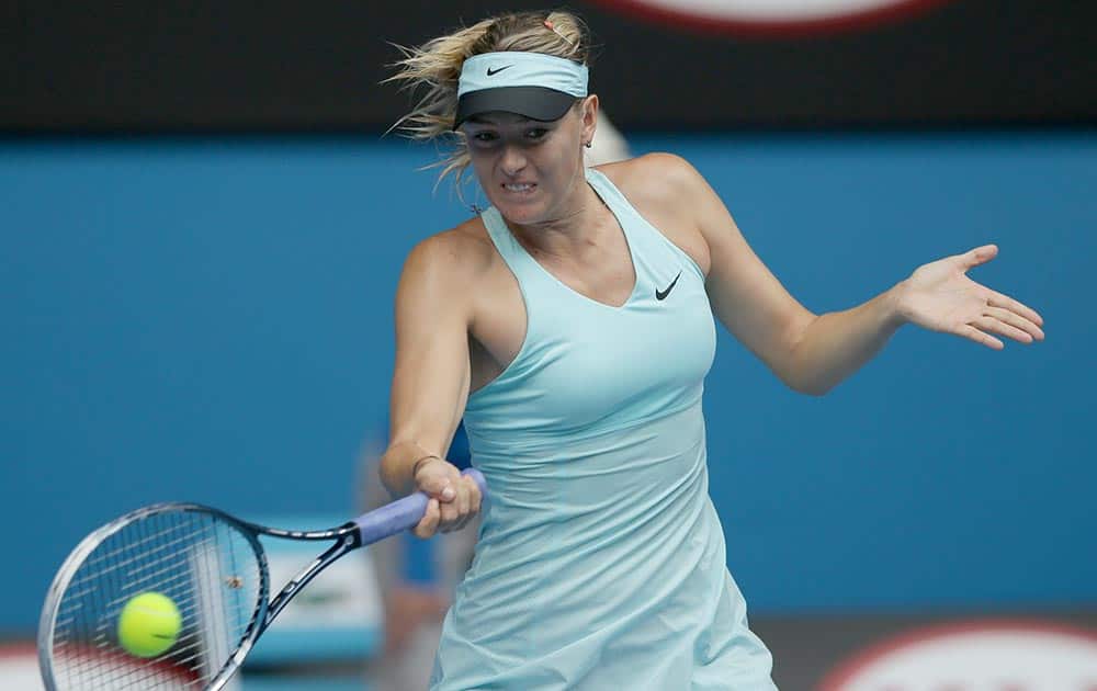 Maria Sharapova of Russia hits a forehand return to Alize Cornet of France during their third round match at the Australian Open tennis championship in Melbourne, Australia.