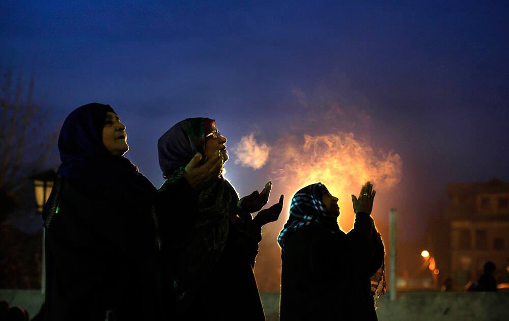 Kashmiri Muslim devotees raise their hands in prayer as a head priest displays a relic of Islam`s Prophet Muhammad at the Hazratbal shrine on the Friday following Eid-e- Milad, the birth anniversary of the Prophet, in Srinagar.