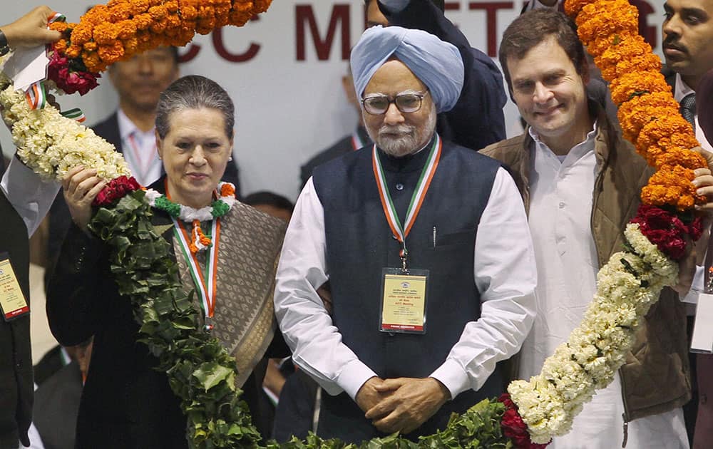 Prime Minister Manmohan Singh, Congress party President Sonia Gandhi and party Vice-President Rahul Gandhi being garlanded during AICC meeting in New Delhi.