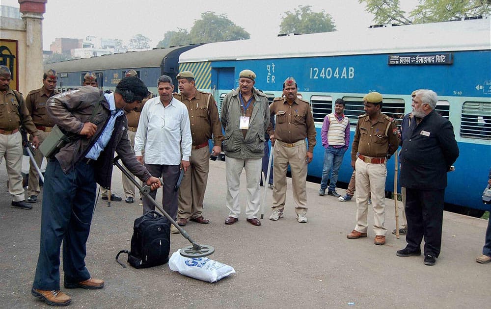 Bomb disposal squad members inspecting a bag after receiving a message of live bomb in a bag in the Vibhuti Express train at Allahabad station.