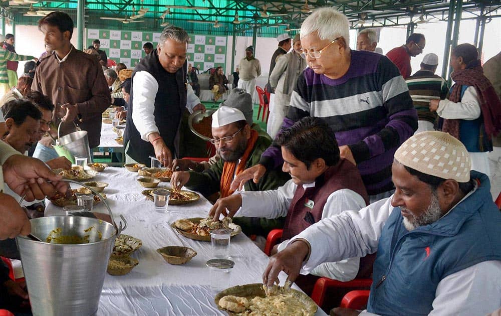 RJD Chief Lalu Prasad distributing Dahi -Chura to his party Muslim supporters during Makar Sankranti celebration in Patna.