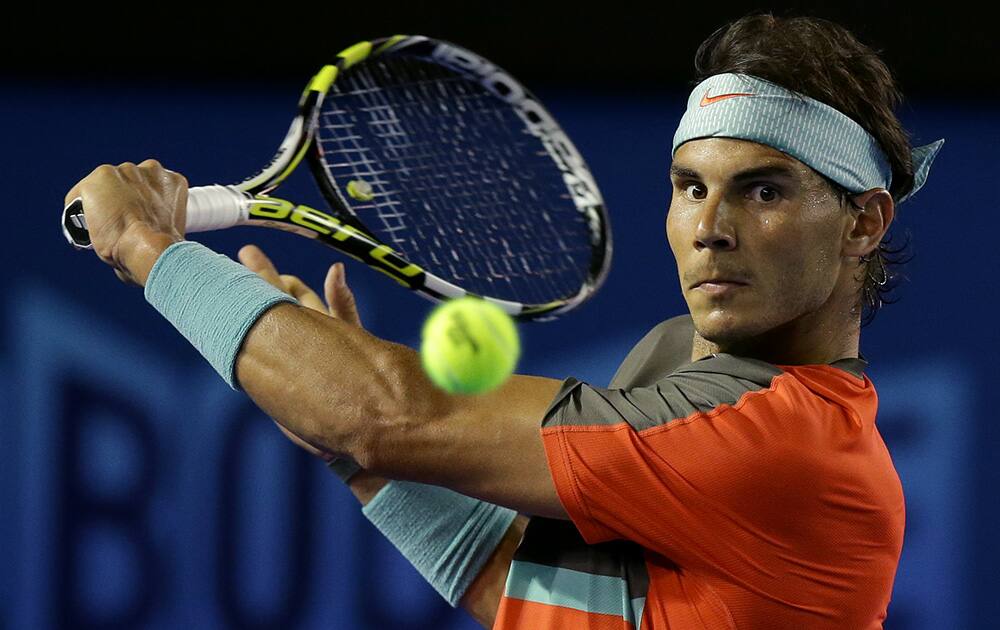 Rafael Nadal of Spain makes a backhand return to Thanasi Kokkinakis of Australia during their second round match at the Australian Open tennis championship in Melbourne, Australia.