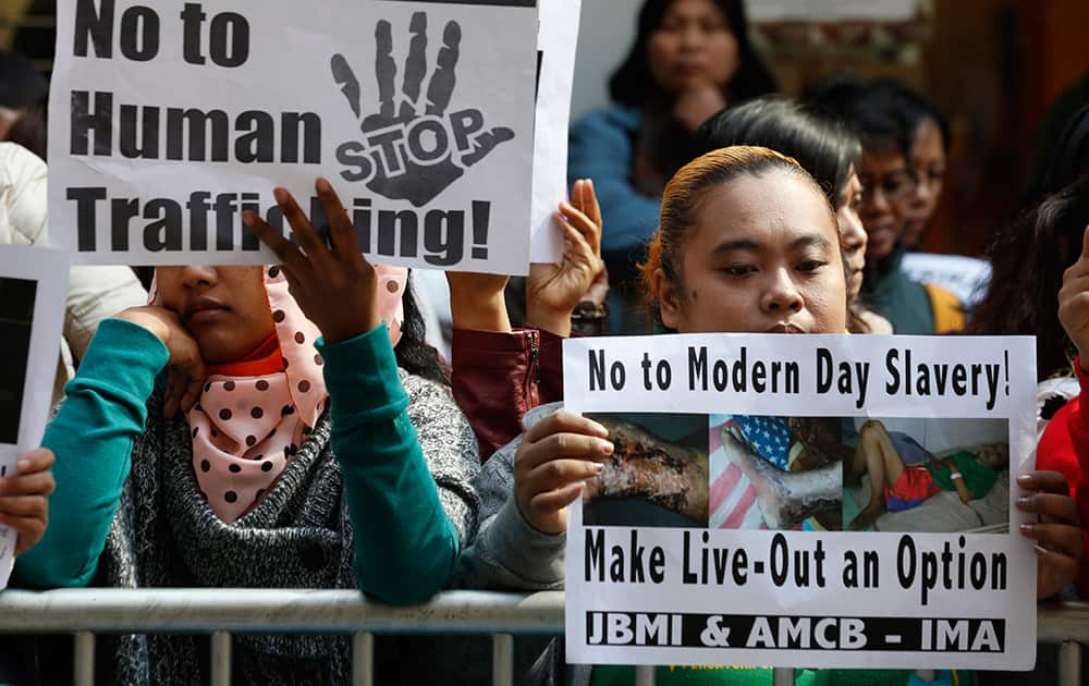 Foreign maids display pictures of 23-year-old Indonesian maid Erwiana Sulistyaningsih during a protest outside the Indonesian Consulate in Hong kong. The Indonesian maid who was allegedly brutally tortured by her employers for months has become the latest case to trigger outrage in Hong Kong over abuses commonly suffered by the city’s army of foreign migrant workers.