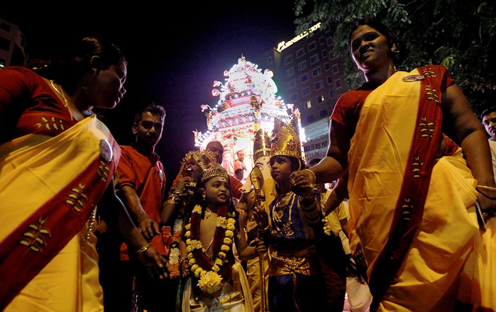 Malaysian Hindu devotees gather to offer prayers and get blessings from the Lord Murugan`s chariot during a procession to mark the start of Thaipusam, an annual festival symbolizing the struggle between good and evil, in Kuala Lumpur, Malaysia.