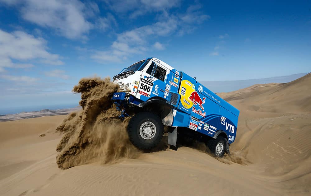 Driver Andrey Karginov and co-pilots Andrey Mokeev and Igor Devyatkin, all from Russia, ride their Kamaz truck up a dune during the tenth stage of the Dakar Rally between the cities of Iquique and Antofagasta, Chile.
