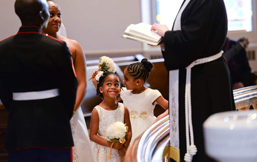 Peyton Wilcox, 4, smiles as her parents; Marine Corps Sgt. Stanly Wilcox and his wife Tashauna, renew their vows during a Weddings for Warriors ceremony, at Wesley Monumental United Methodist Church in Savannah, Ga. Eleven couples participated in the annual event.