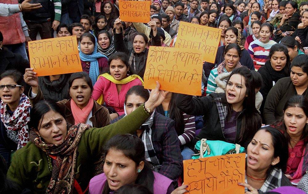 Members of All Guest Teacher Association shout slogans during the protest against Delhi Government in New Delhi.