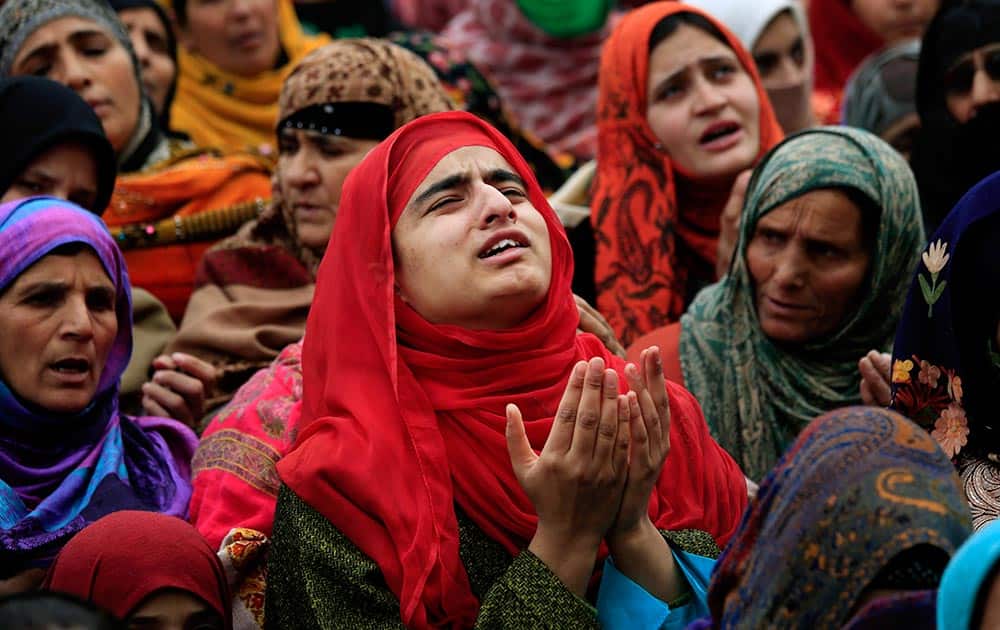 A Kashmiri Muslim woman prays among others as a head priest displays a relic of Prophet Muhammad at the Hazratbal shrine in Srinagar.